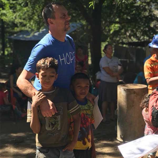 Honduras Well Projects Volunteer Standing with Kids